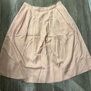 Pink a-line skirt with pleats.